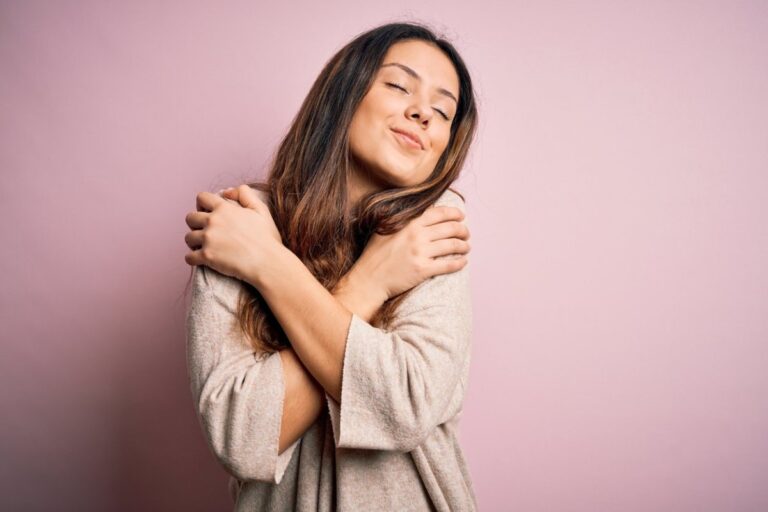 A Women Hugging Herself Showing Positive Emotional Impact - Martin Plastic Surgery Toronto
